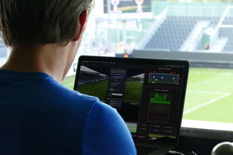 Man analyses goal attempts and player positioning on monitor 