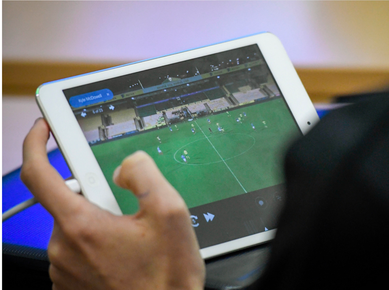Person viewing soccer match videos on a tablet